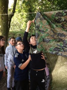 Putting up a tarp to add shelter on rainy days