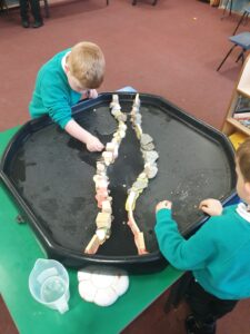 working together to build a dam to stop the river leaking